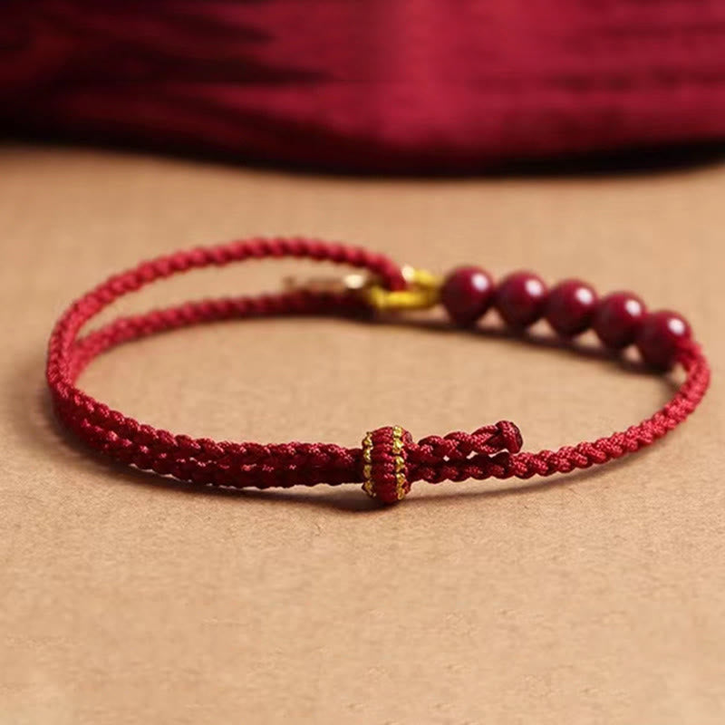 Pulsera trenzada hecha a mano con cuentas de cinabrio y carácter Fu de Buda con hilo rojo bendecido 