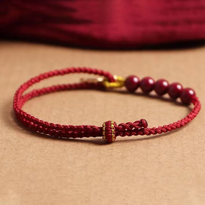 Pulsera trenzada hecha a mano con cuentas de cinabrio y carácter Fu de Buda con hilo rojo bendecido 
