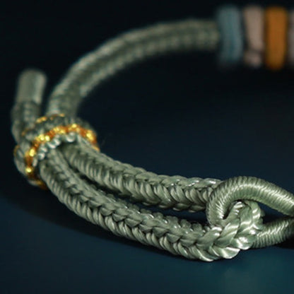 Pulsera de cuatro hilos con piedras de Buda y flor de durazno 