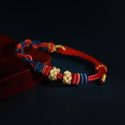 Pulsera de cuatro hilos con piedras de Buda y flor de durazno 