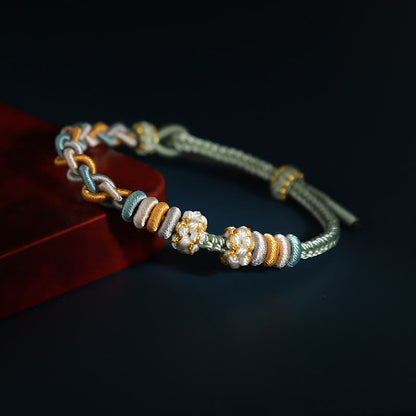 Pulsera de cuatro hilos con piedras de Buda y flor de durazno 