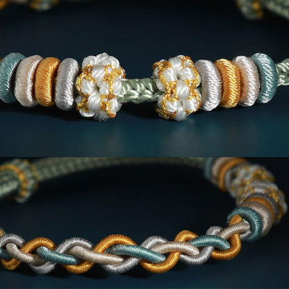 Pulsera de cuatro hilos con piedras de Buda y flor de durazno 