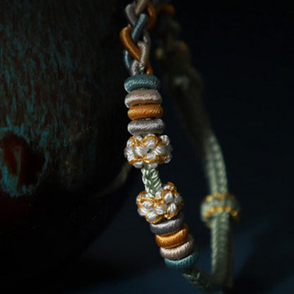 Pulsera de cuatro hilos con piedras de Buda y flor de durazno 