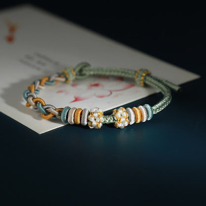Pulsera de cuatro hilos con piedras de Buda y flor de durazno 