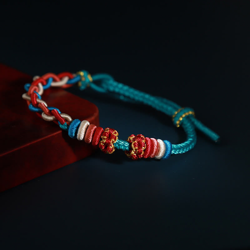 Pulsera de cuatro hilos con piedras de Buda y flor de durazno 