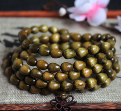 Pulsera de protección de madera natural Phoebe Zhennan con 108 cuentas de lágrima de Buda 