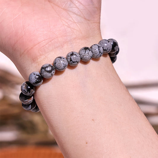 Pulsera de equilibrio de obsidiana y copo de nieve de piedra de Buda