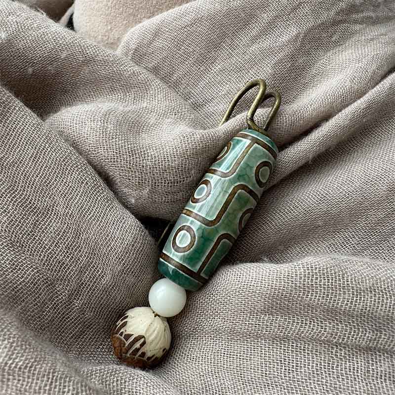 Broche protector de loto con semillas de bodhi y cuentas Dzi de nueve ojos de Buda