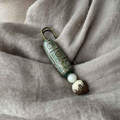 Broche protector de loto con semillas de bodhi y cuentas Dzi de nueve ojos de Buda