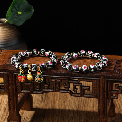 Pulsera de cuentas de vidrio fluorescentes Liuli con corazón de amor rosa y piedras de Buda doradas.