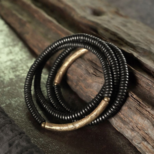 Pulsera multicapa de equilibrio de cobre, madera de ébano y piedras de Buda