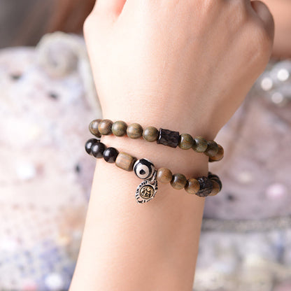 Pulsera de doble vuelta con cuentas Dzi de tres ojos de madera de ébano y sándalo verde tibetano con piedras de Buda y carácter Fu, equilibrio y paz.