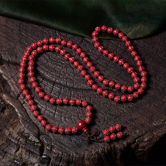 Pulsera de 108 cuentas de mala de Buda con cinabrio y patrón Om Mani Padme Hum grabado. 