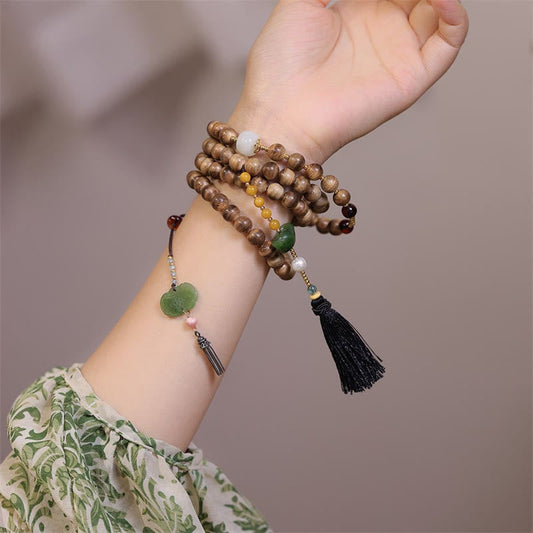 Pulsera con dijes de Ruyi, borlas, lingotes de jade, ámbar y madera de agar natural con piedras de Buda