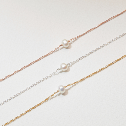 Conjunto de regalo de gargantilla y pulsera con una perla dorada