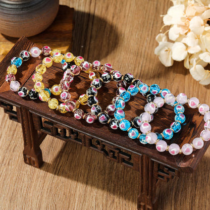 Pulsera de cuentas de vidrio fluorescentes Liuli con corazón de amor rosa y piedras de Buda doradas.