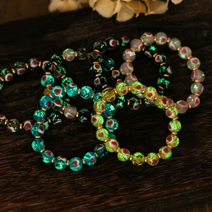 Pulsera de cuentas de vidrio fluorescentes Liuli con corazón de amor rosa y piedras de Buda doradas.