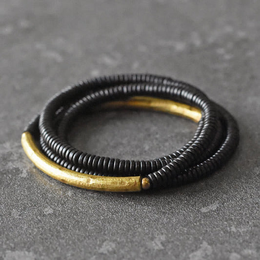 Pulsera multicapa de equilibrio de cobre, madera de ébano y piedras de Buda