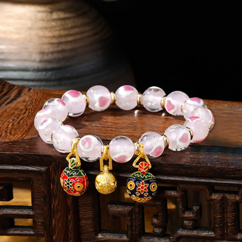Pulsera de cuentas de vidrio fluorescentes Liuli con corazón de amor rosa y piedras de Buda doradas.