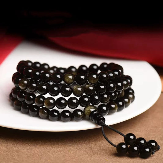Pulsera de obsidiana con 108 cuentas de mala de Buda y brillo dorado natural