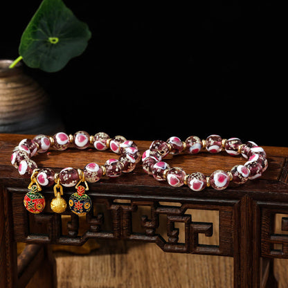 Pulsera de cuentas de vidrio fluorescentes Liuli con corazón de amor rosa y piedras de Buda doradas.