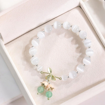 Pulsera con dijes de orquídea de la paz, calcedonia azul, aventurina verde y ojo de gato de Buda