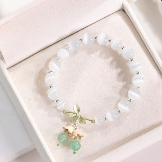Pulsera con dijes de orquídea de la paz, calcedonia azul, aventurina verde y ojo de gato de Buda