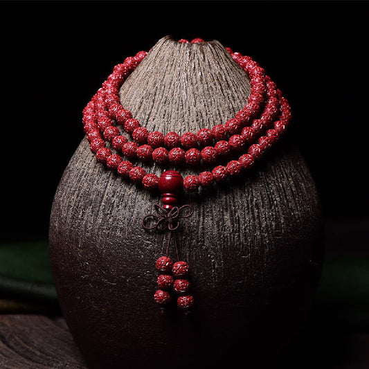 Pulsera de 108 cuentas de mala de Buda con cinabrio y patrón Om Mani Padme Hum grabado. 