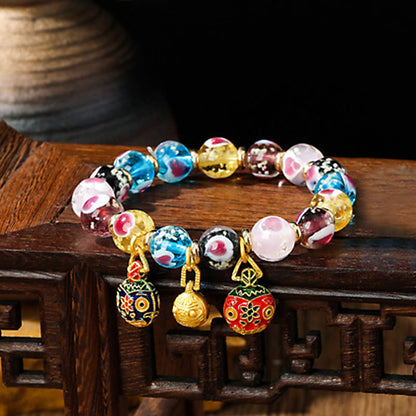 Pulsera de cuentas de vidrio fluorescentes Liuli con corazón de amor rosa y piedras de Buda doradas.