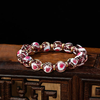 Pulsera de cuentas de vidrio fluorescentes Liuli con corazón de amor rosa y piedras de Buda doradas.