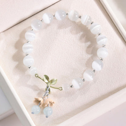 Pulsera con dijes de orquídea de la paz, calcedonia azul, aventurina verde y ojo de gato de Buda